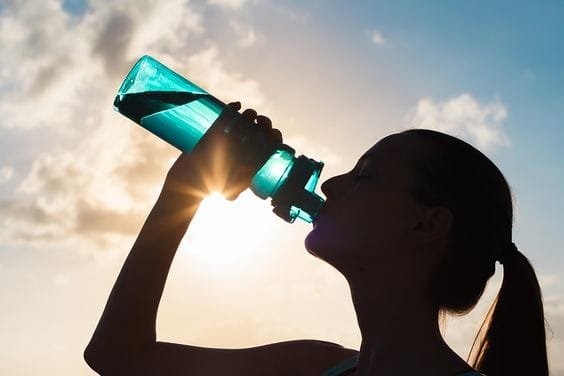 Girl Drinking water while traveling
