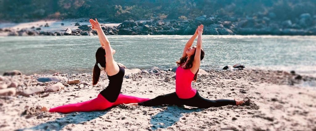 Image of 2 girls doing yoga in india